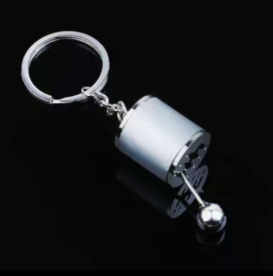 Shifter keychain with realistic mini gear shifter design.