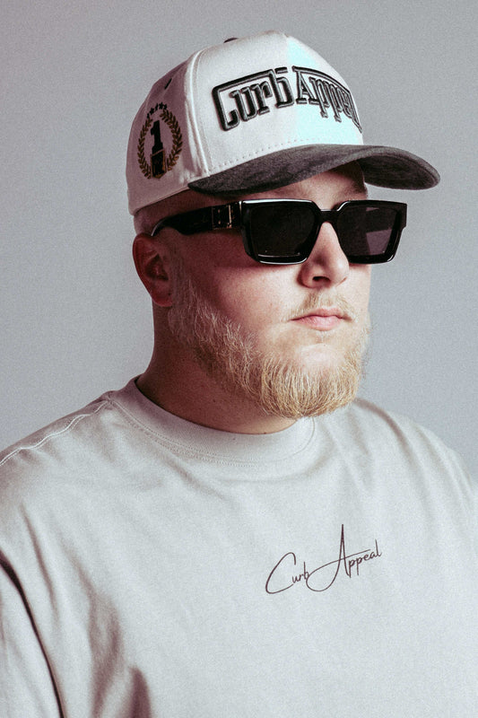 Man wearing Porsche RWB Tee, styled with a cap and sunglasses.