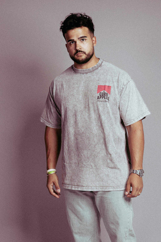 Vintage style acid wash tee by Curb Appeal worn by a model.