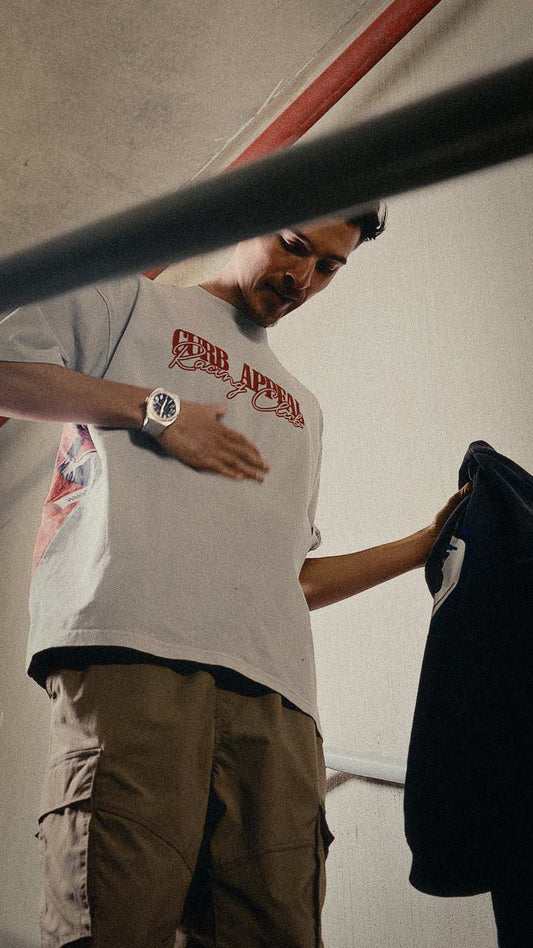 Marlboro Racing Club Tee with red "Curb Appeal Racing Club" logo, worn by man indoors.