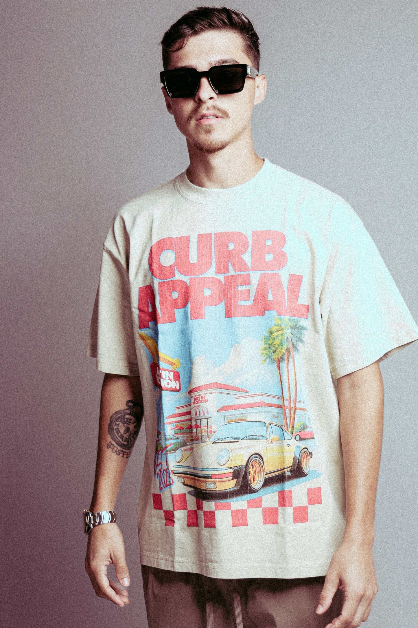 In & Out Porsche Tee featuring artistic car scene and bold statement, embodying street culture.