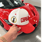 The Winner's Circle Hat with red suede bill and 3D stitching, inspired by racing culture.