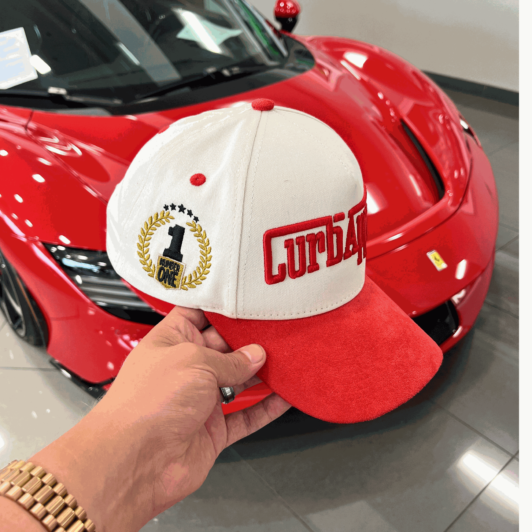 The Winner's Circle Hat with red suede bill and 3D stitching, inspired by racing culture.