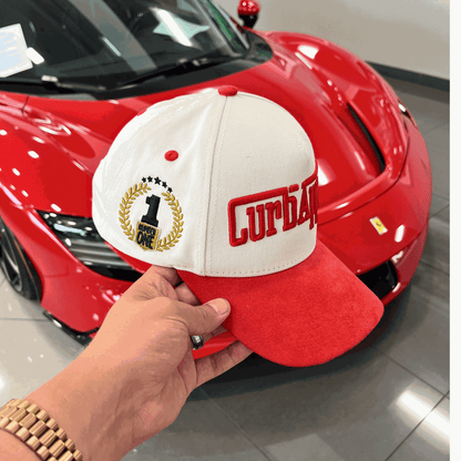The Winner's Circle Hat with red suede bill and 3D stitching, inspired by racing culture.