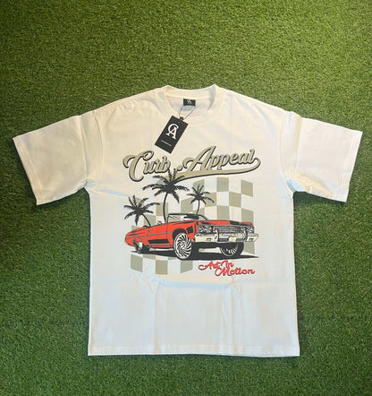 Donk Tee featuring a vibrant graphic design with a red car, palm trees, and an urban theme on a white T-shirt.