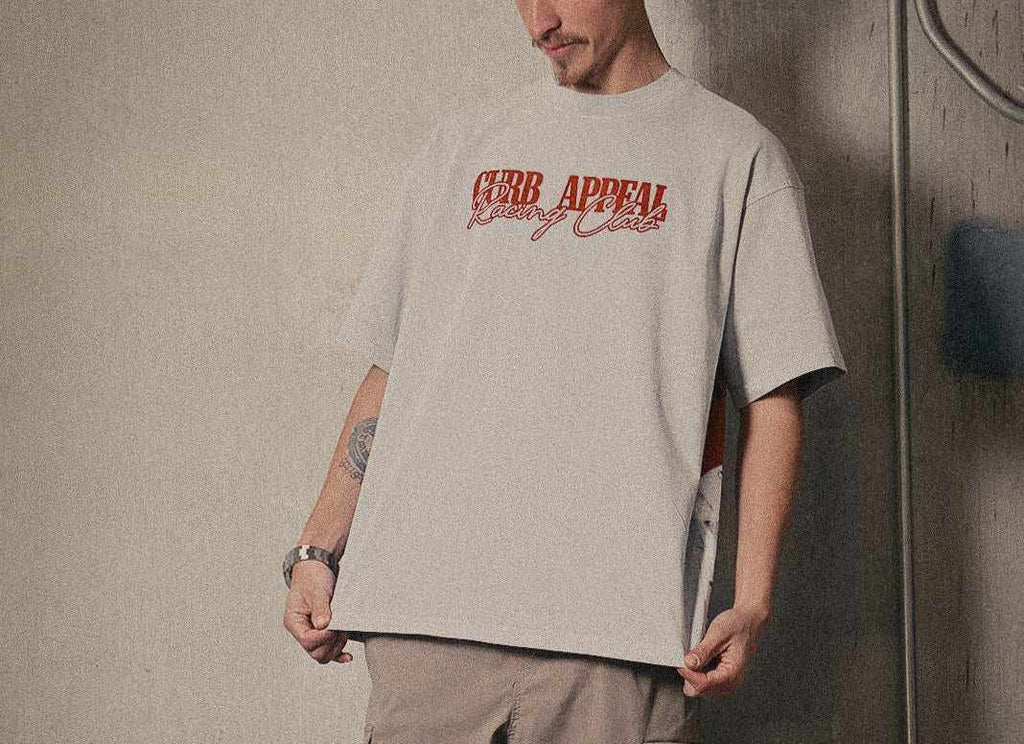 Marlboro Racing Club Tee with red "Curb Appeal Racing Club" logo, worn by model in relaxed fit, featuring iconic racing graphic on back.