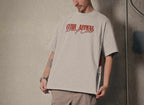 Marlboro Racing Club Tee with red "Curb Appeal Racing Club" logo, worn by model in relaxed fit, featuring iconic racing graphic on back.