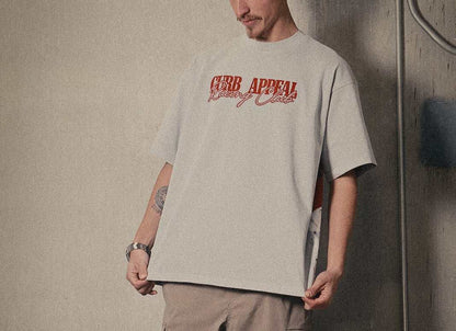 Marlboro Racing Club Tee with red "Curb Appeal Racing Club" logo, worn by model in relaxed fit, featuring iconic racing graphic on back.