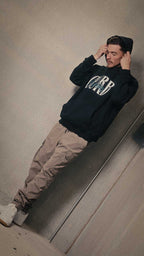 Soft high neck hoodie with curb appeal design worn by a model in a casual setting.
