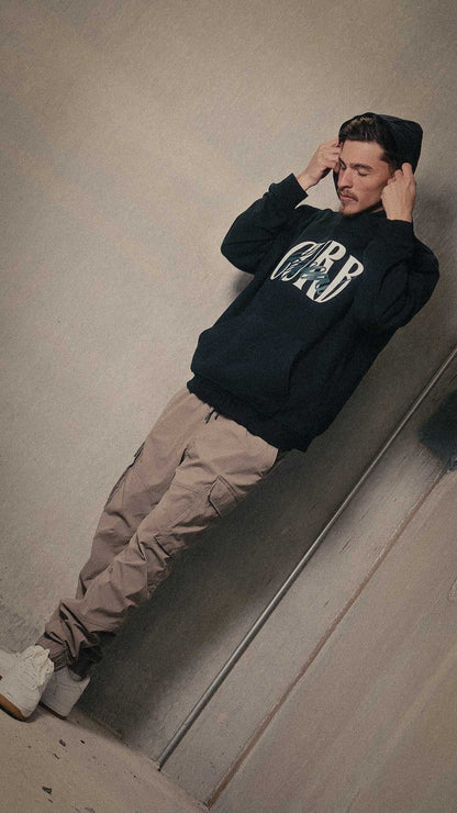 Soft high neck hoodie with curb appeal design worn by a model in a casual setting.