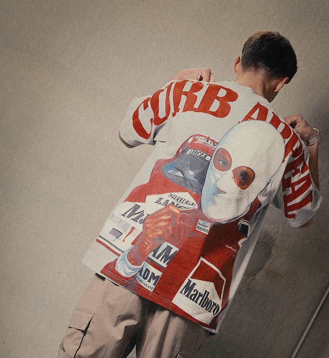 Marlboro Racing Club Tee with bold racing graphics and red logo, modeled by a person.