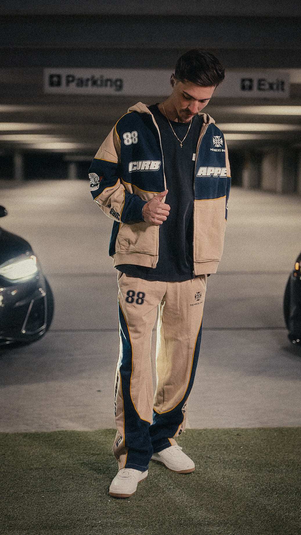 Motorsport set featuring a zip-up hoodie and joggers, modeled in a relaxed fit.