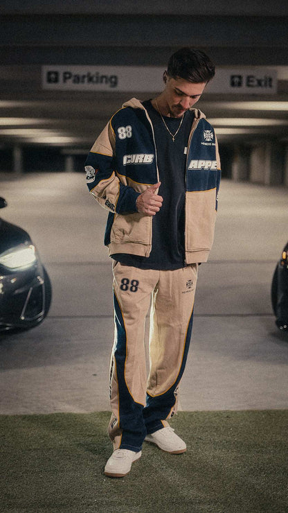 Motorsport set featuring a zip-up hoodie and joggers, modeled in a relaxed fit.