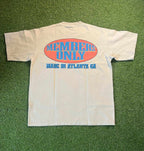 Members Only tee with bold graphics, designed in Atlanta, on a grassy background.