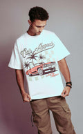 Donk Tee featuring vibrant Donk car graphic, urban backdrop, and Curb Appeal branding on a white T-shirt worn by a model.