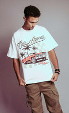Donk Tee featuring vibrant Donk car graphic, urban backdrop, and Curb Appeal branding on a white T-shirt worn by a model.