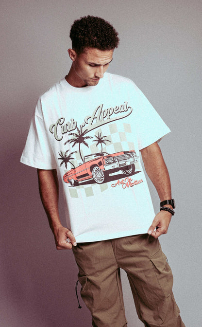 Donk Tee featuring vibrant Donk car graphic, urban backdrop, and Curb Appeal branding on a white T-shirt worn by a model.