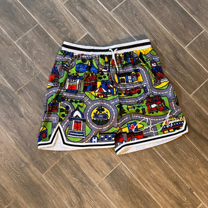 Nostalgia mesh shorts with all-over car mat print on wooden floor.
