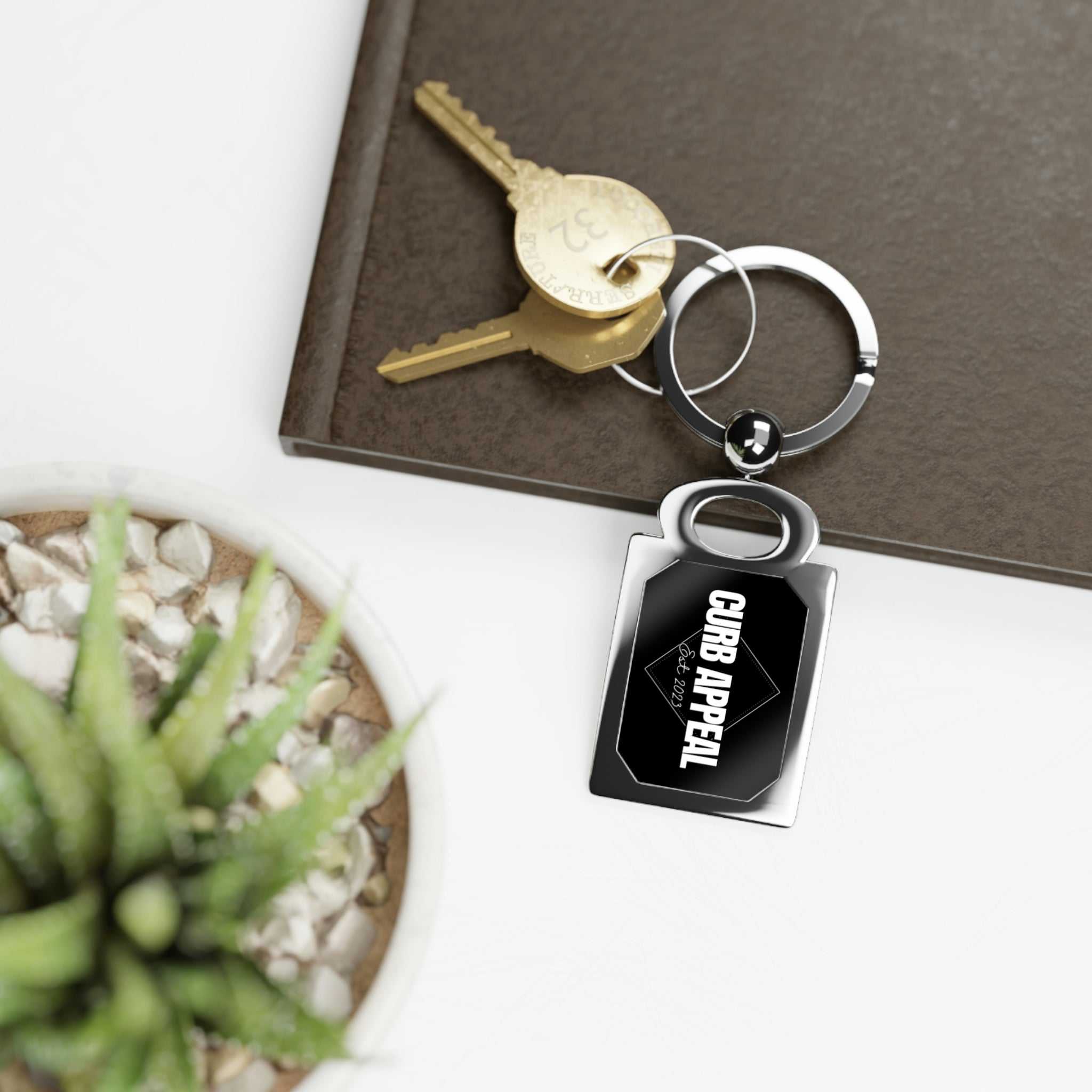 Sleek Logo Keychain with polished emblem, durable build, and compact design.