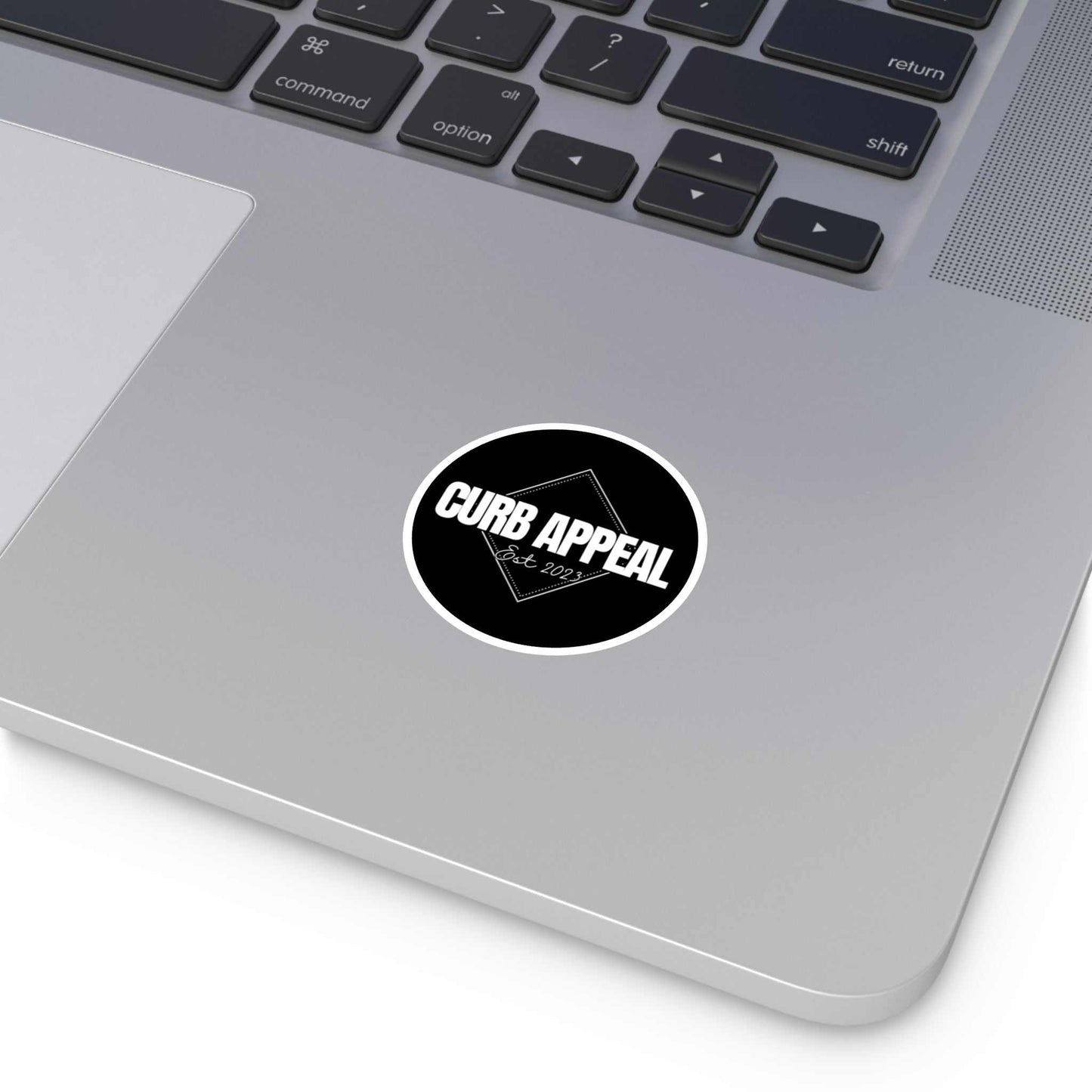 High-quality vinyl logo sticker on laptop; weatherproof and UV-resistant design.